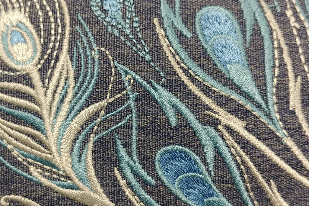 close up view of peacock feather stitching