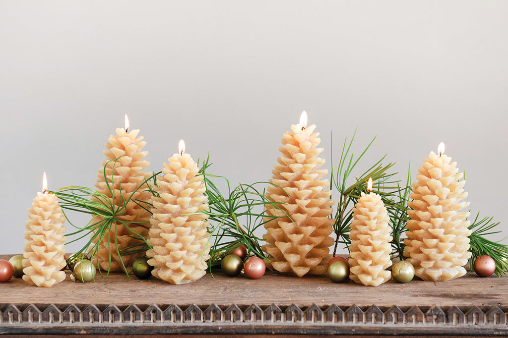 table display of honey pinecones, small ornaments and pine needles 