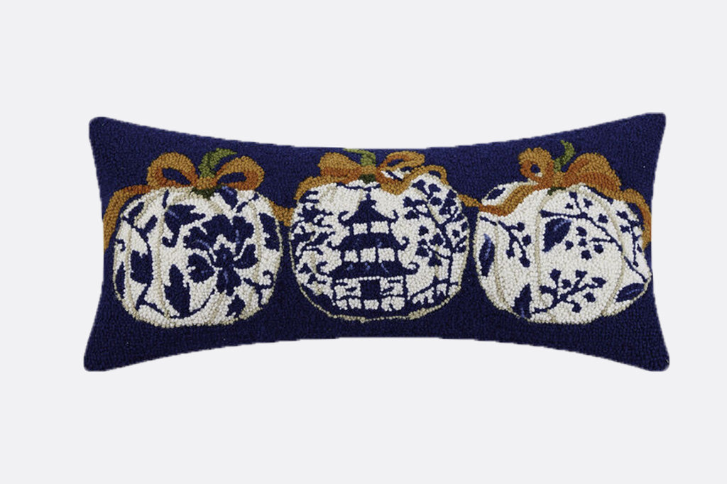 hooked wool pillow in lumbar dimensions shows 3 asian themed pumpkins on blue background