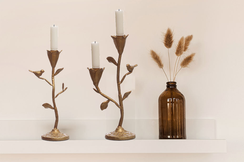 taper candelabra featuring floral cups to hold the candle and perched bird in a golden bronze finish
