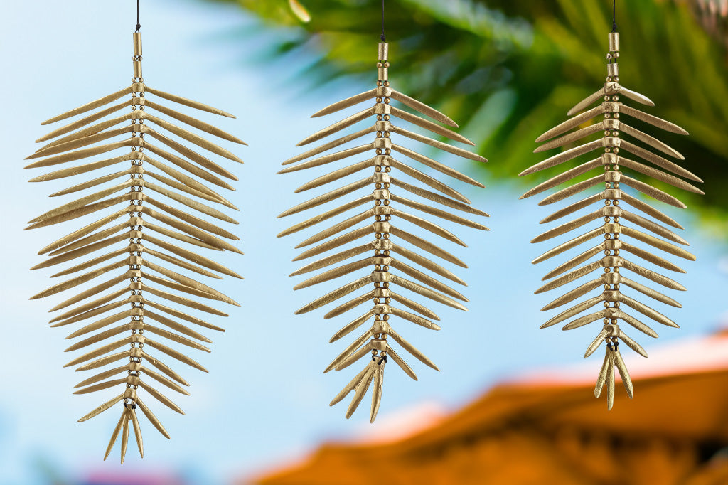 Three of the cayo coco wind art hang in a tropical environment