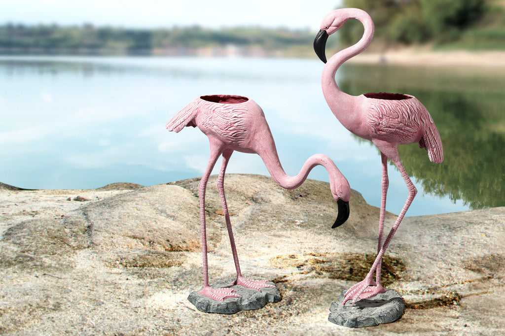 flamingo planters shown by a lake
