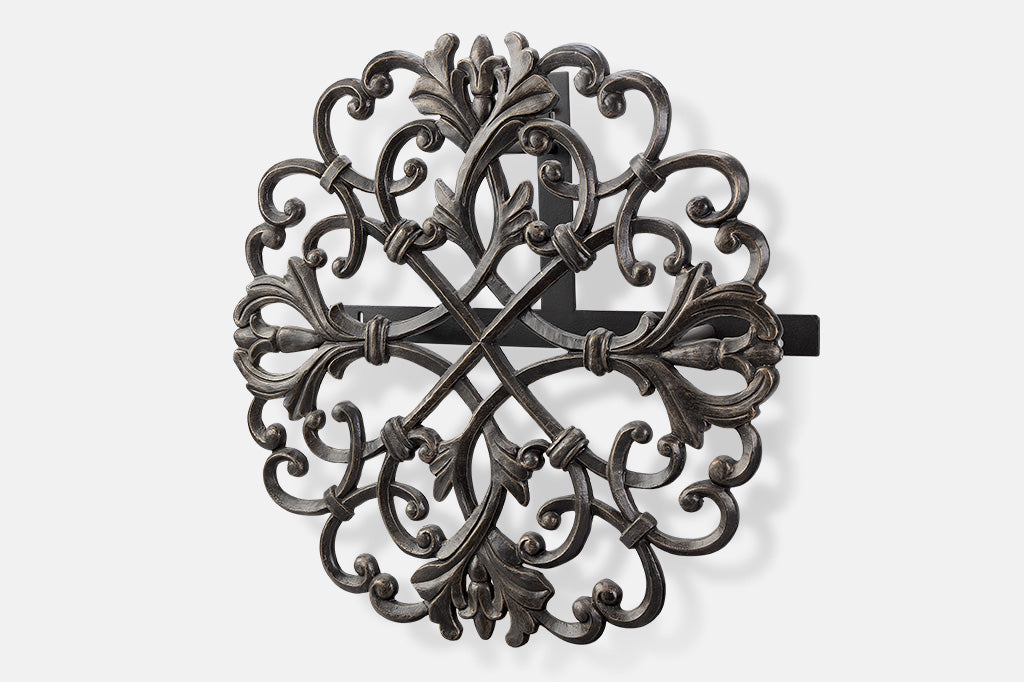 Side view of scrollwork on a wall-mounted hose holder