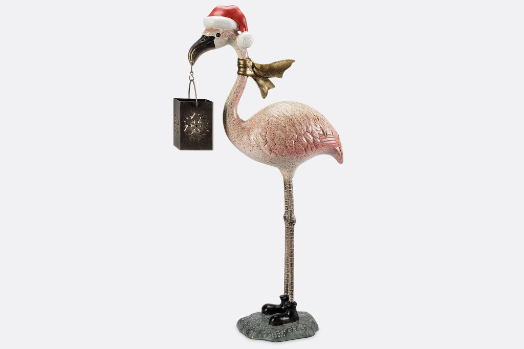 Flamingo holiday sculpture lantern shown with gold scarf and santa hat in red and white