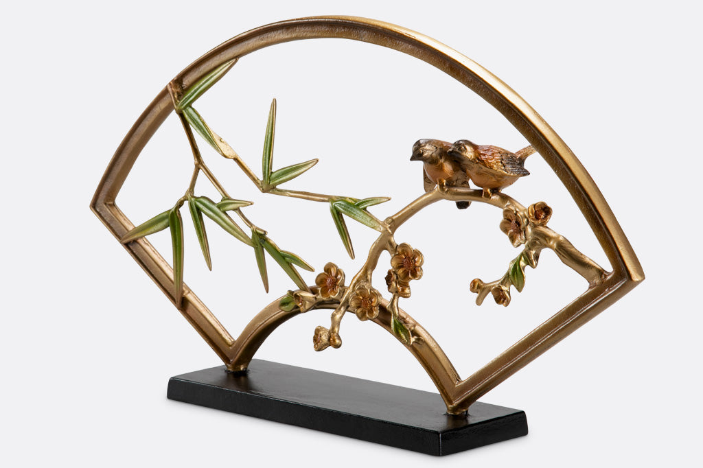 "tranquility sculpture" is a fan shaped table sculpture with bamboo, blossom, and bird features with shimmering features