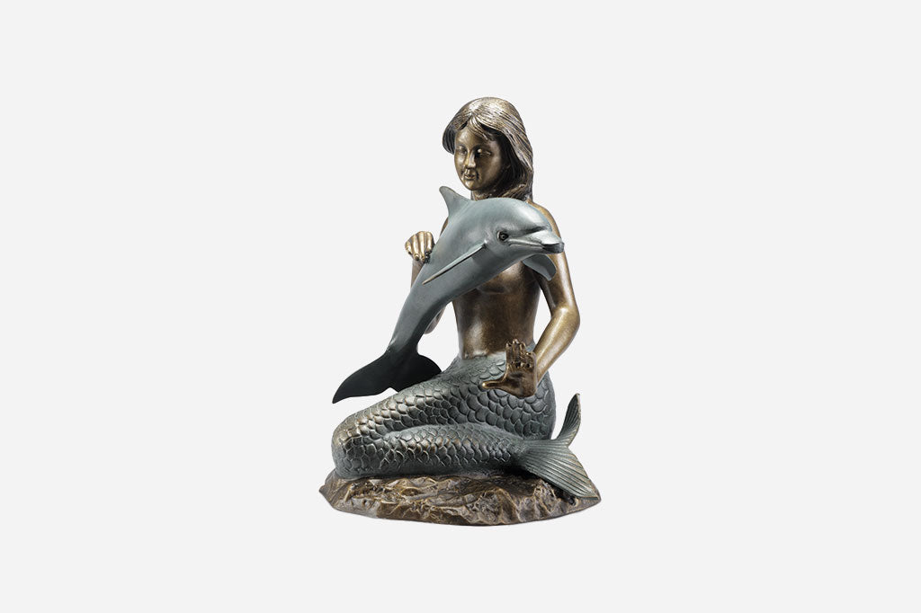 Bronze and verdi cast metal sculpture of a mermaid encountering a dolphin