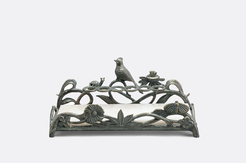 metal vanity tray with floral, bird and snail detailing. Special rings to hold lipsticks and a white marble base. 