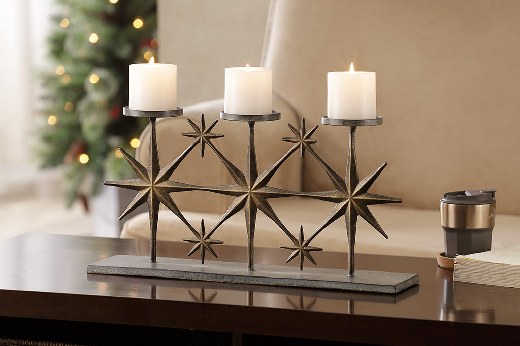 Starry candle holder holding three votive candles on coffee table 
