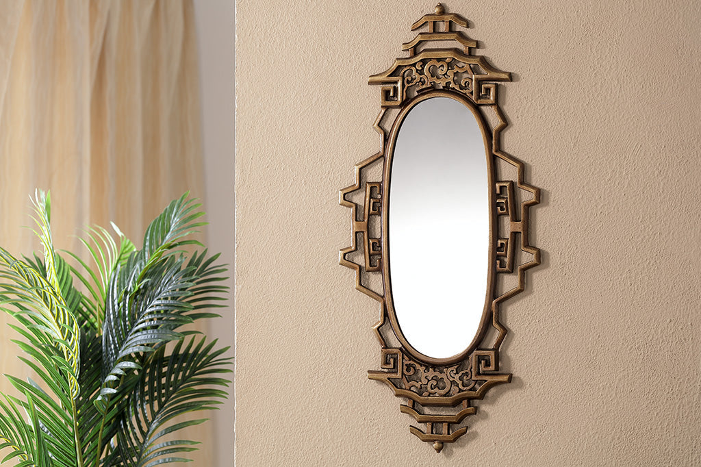 gold wall mirror with asian inspired details 
