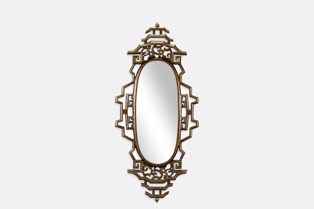 gold wall mirror with asian details on gray background 