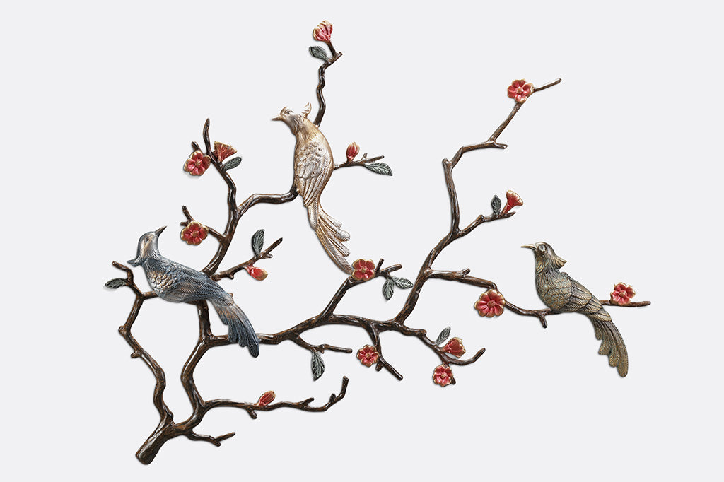 wall art of blossoming branches with three birds one light gold, one bronze and one with a metallic grey-blue tone