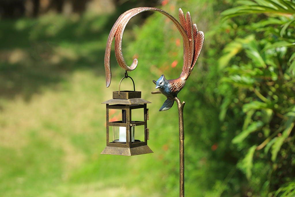 Flycatcher outdoor staked lantern with votive candle staged in garden background 