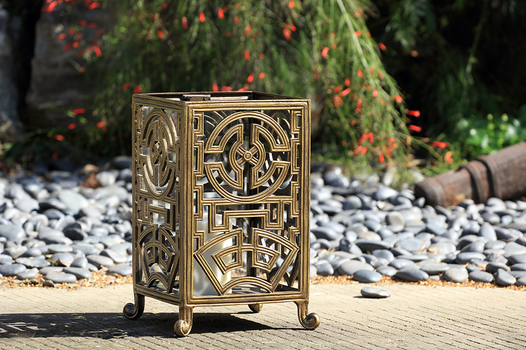 Ming fretwork lantern staged outside with rocks and nature 