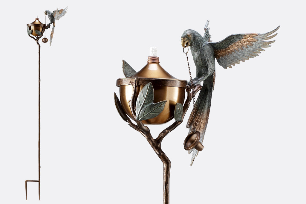 Outdoor Garden Torch with parrot on a leafy branch.  Close-up view of parrot and full-height product view shown.