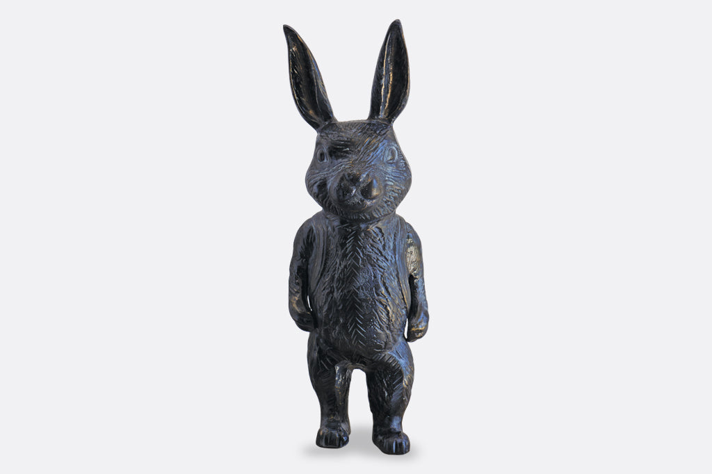 Black metal bunny sculpture with blue and bronze highlights
