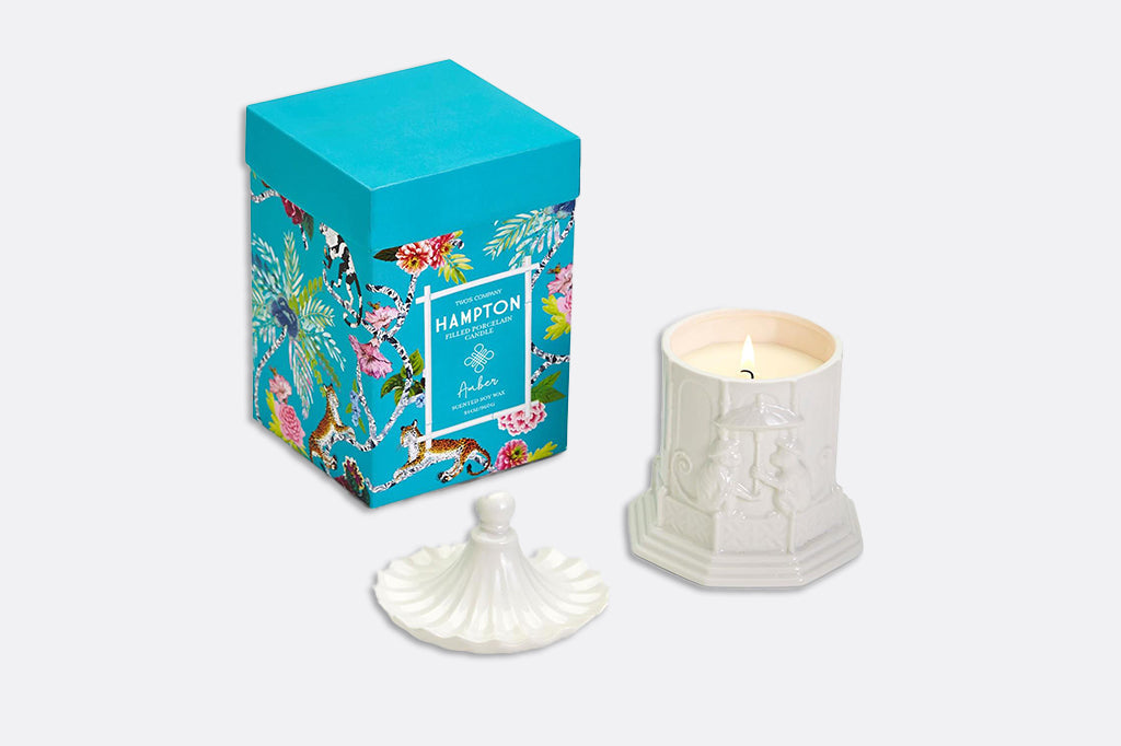 Pagoda candle with lid staged next to printed blue box 
