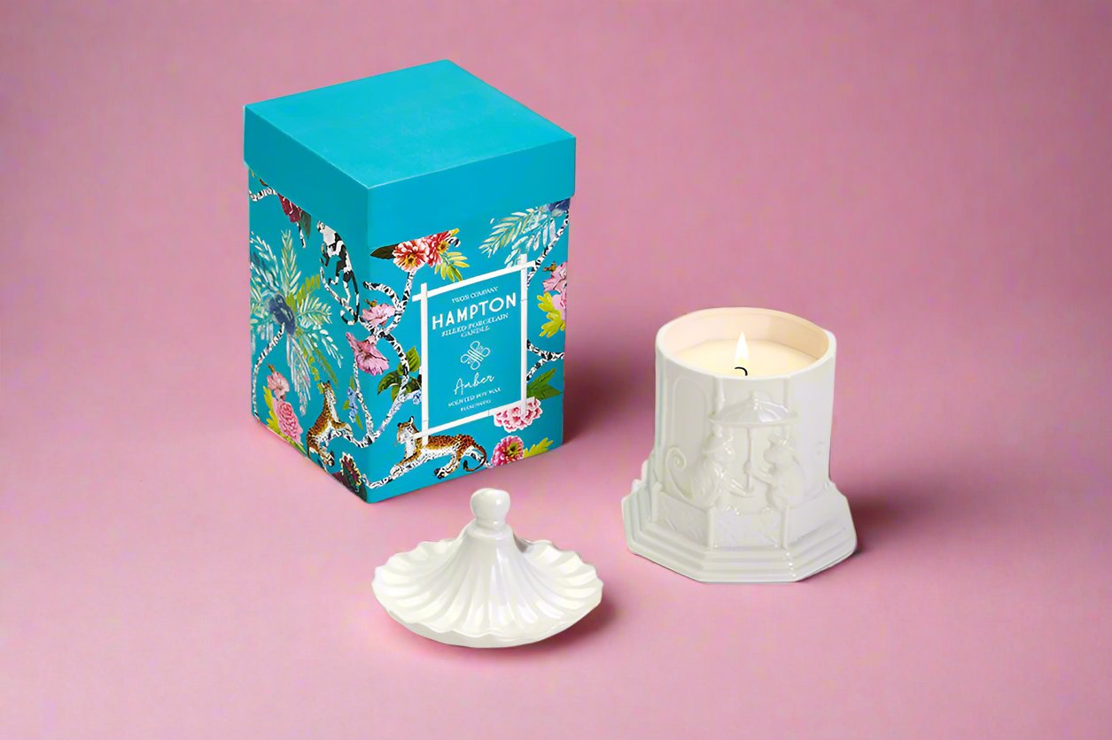 Pagoda candle with lid staged next to printed blue box 