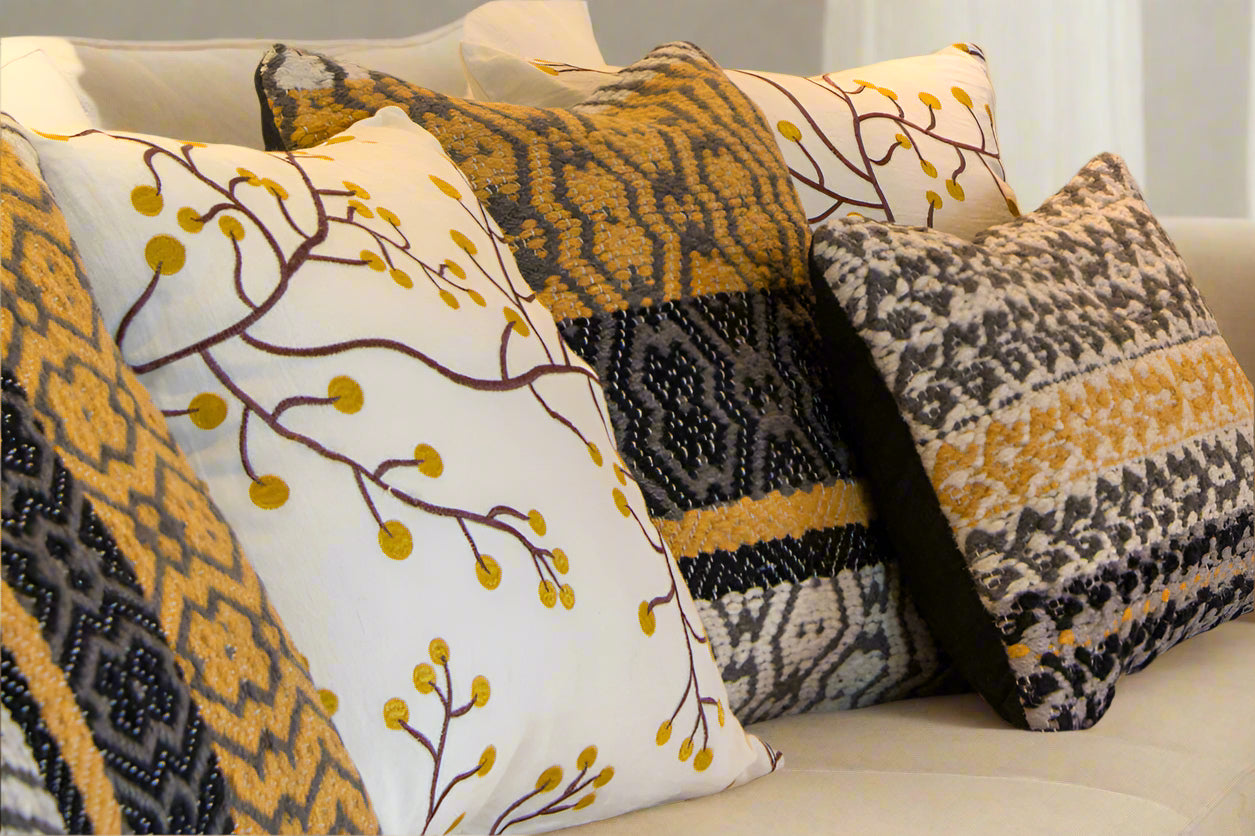 Textured pillow grouping in shades of golden yellow, white, and black
