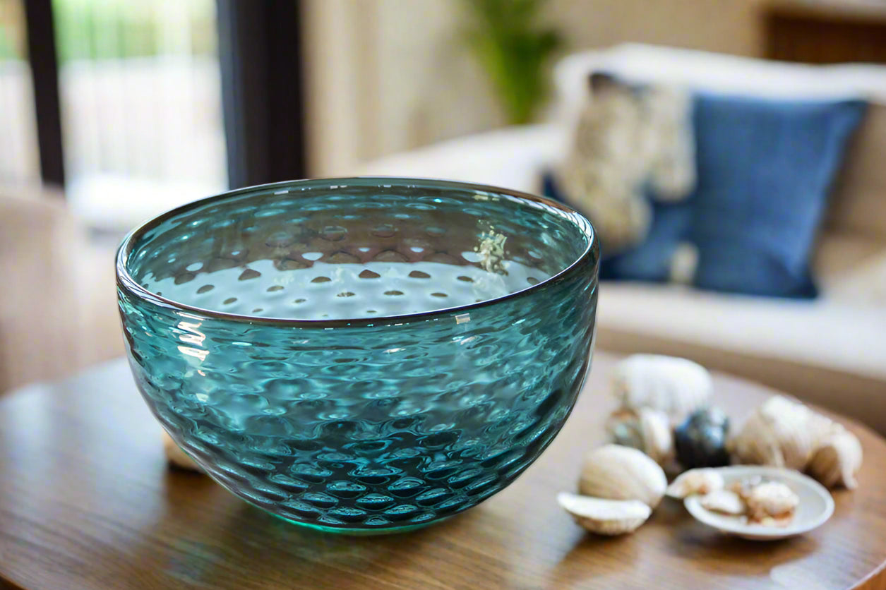 Large art glass basin shows sea blue coloring and dimpled glass texture