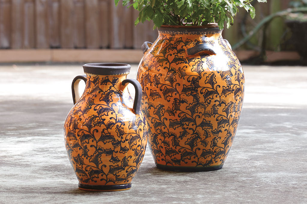 Cachi Jar on right; Arancione Vase on Left on a garden patio.