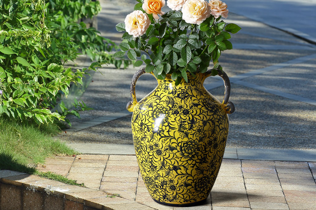Giallo vase holding roses on a patio