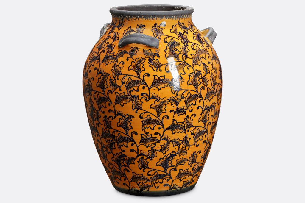 leaf and vine printed tall ceramic jar; gray handles and rim; deep orange-yellow glaze