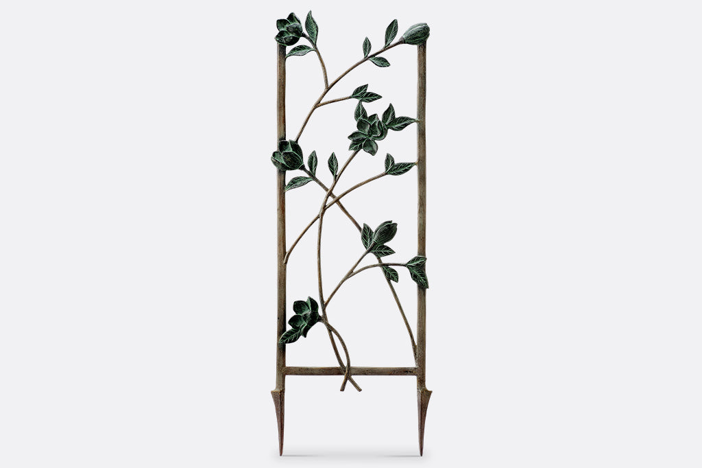 Magnolias Trellis Tall is cast metal with verdigris blossoms and branches on a bronze frame