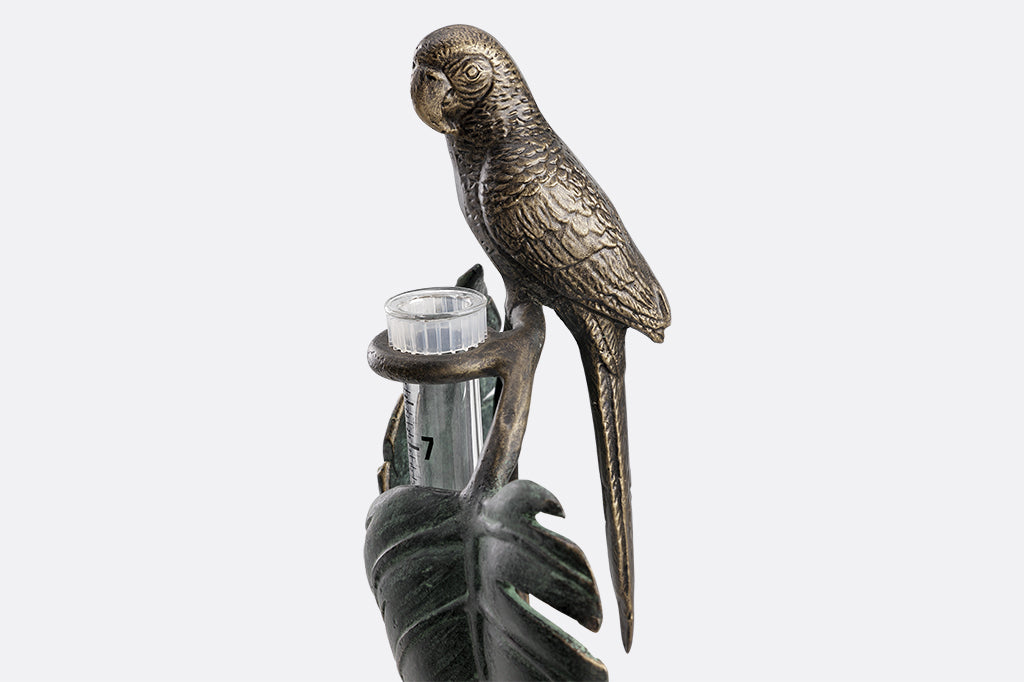 close up view of rain catcher sculpture - features a parrot