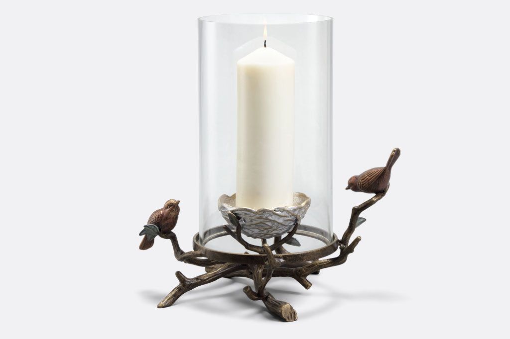 Sculpted bird and nest hurricane glass candle holder shown with 9 inch candle.