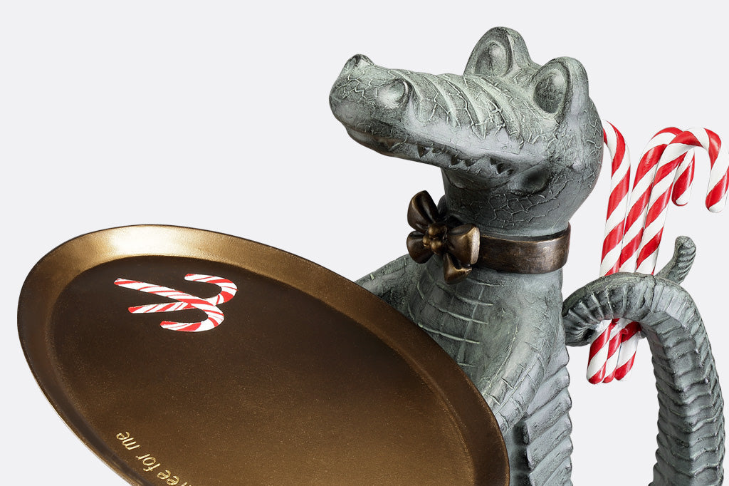 Holiday décor: Standing Crocodile dressed as a butler holds a serving tray whilst hiding candy canes behind its back.