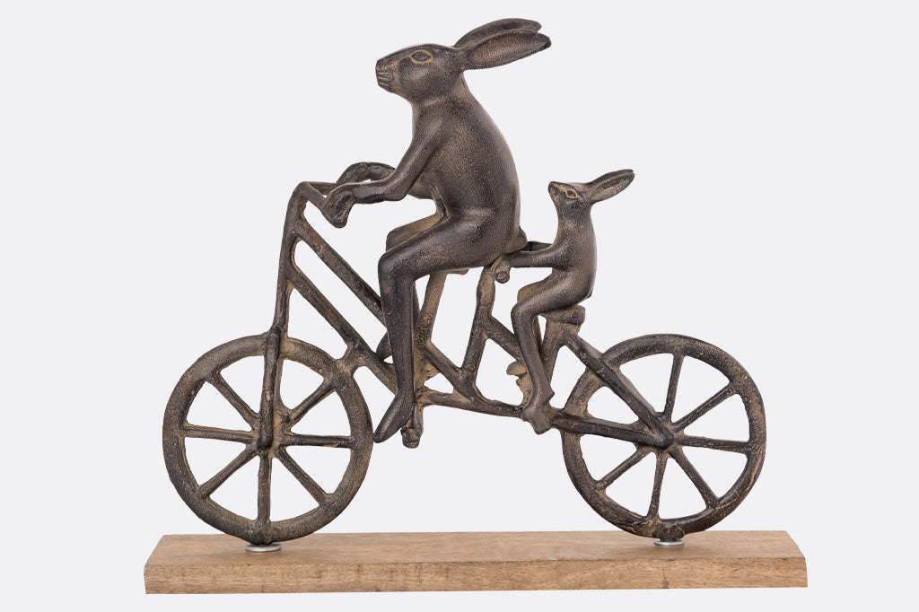 A sculpture of a pair of rabbits sharing a tandem bike