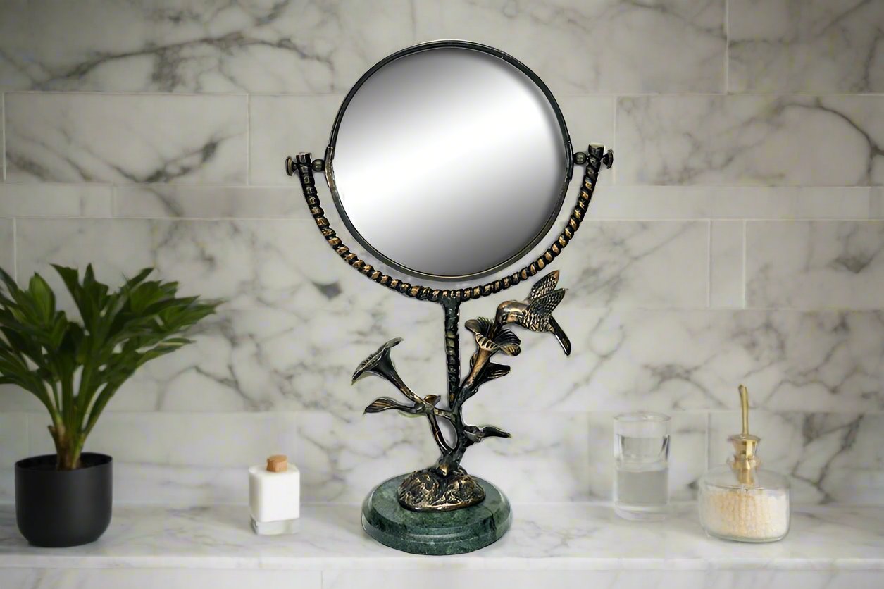 vanity mirror with marble base and stem of blossom and hummingbird motif